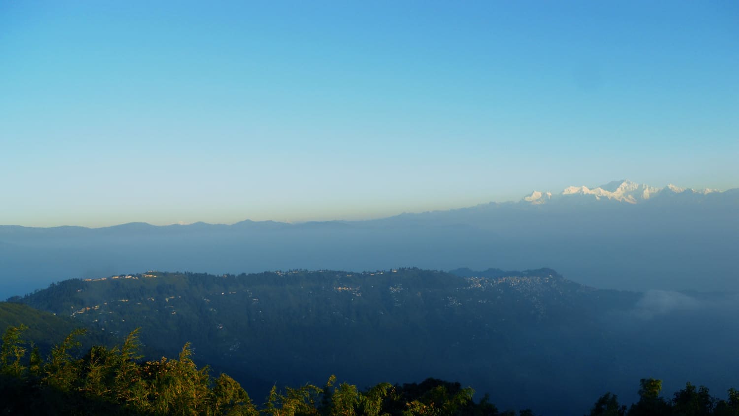 Sunrise lighting the snow peaks of the Kanchenjunga range, seen from Tiger Hill near Darjeeling
